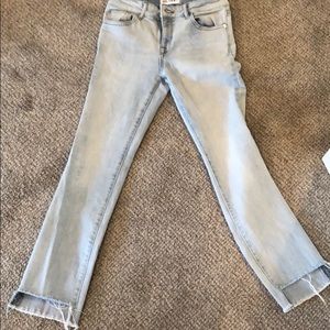 Light wash jeans w/ a step hem